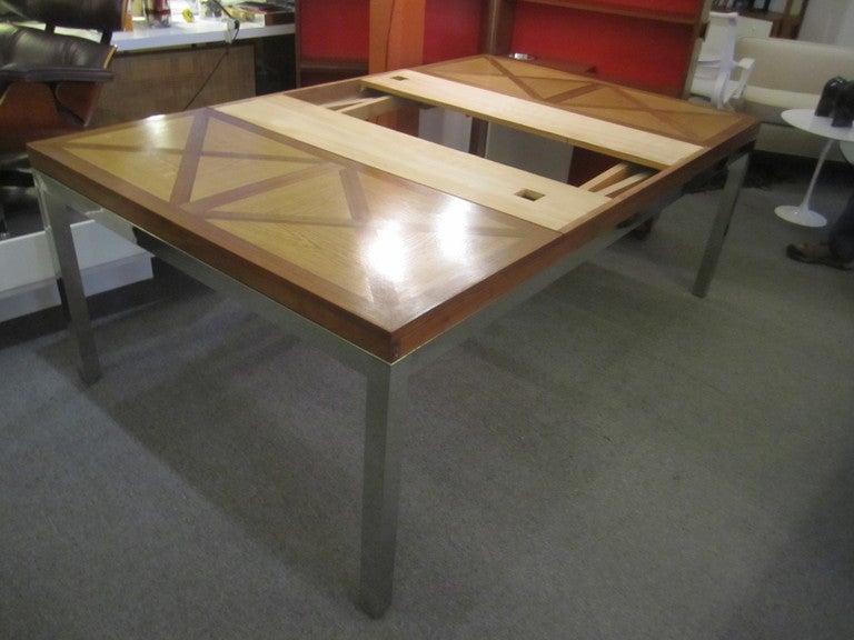 Very large dining table custom made for Rittenhouse Square apartment in Philadelphia in the 1960's.  Table was bought from original owner.  Two refractible leaves  with dimples allow fingers to pull out leaves .  Parkay top consists of large squares